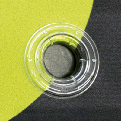Plastgrommet - Clear eyelet 12mm. (1000 pcs) — Supplier application photograph of the PLASTGrommet clear 12mm eyelet. One installed eyelet is shown; the 1000-piece pack is specified in the title. The rear washer is a separate product.